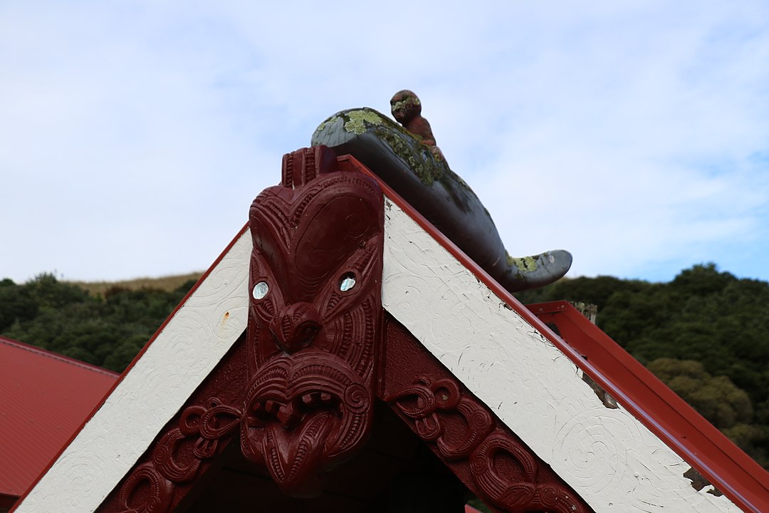 carving of the whale rider paikiea on a rooftop