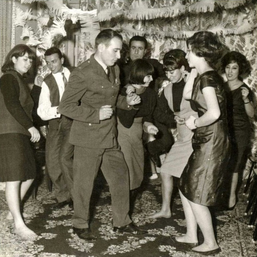 black and white photo of young people dancing in iran