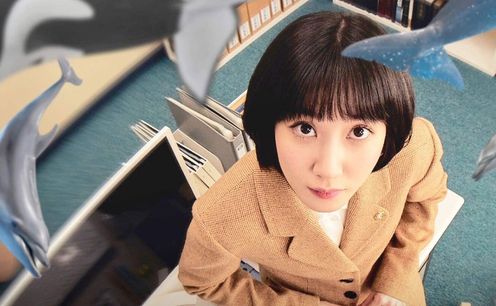 overhead image of south korean actress Park Eun Bin who portrays attorney woo looking up at the camera
