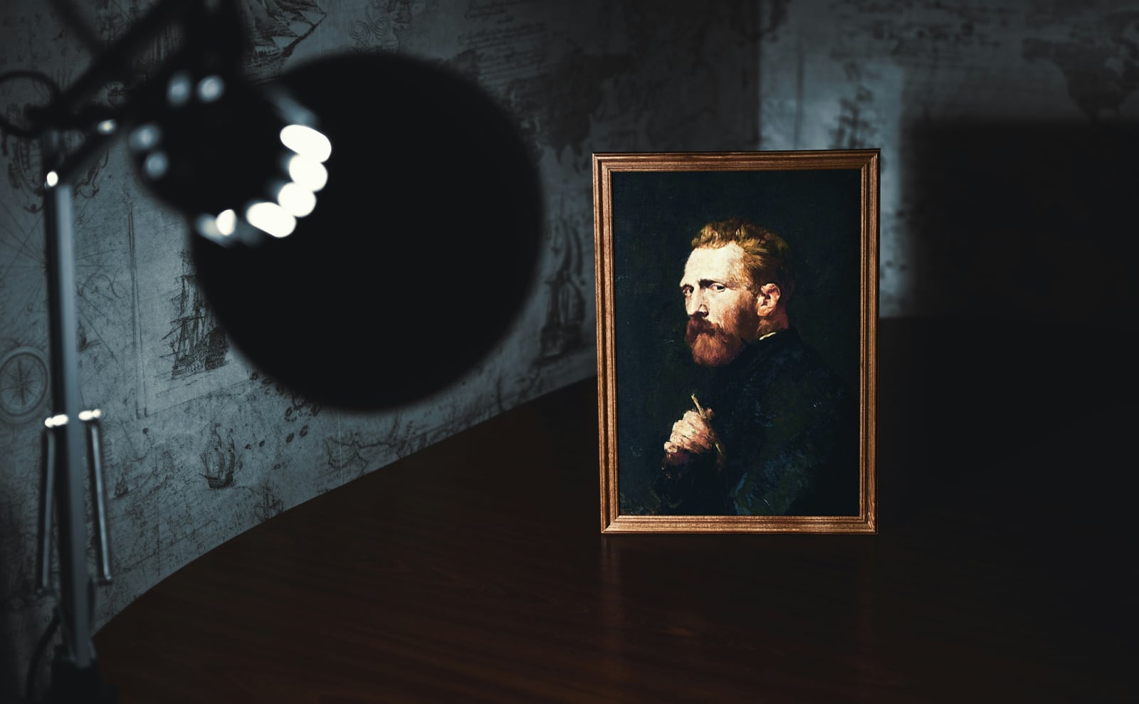 dark room with one bright light shining on a portrait of vincent van gogh