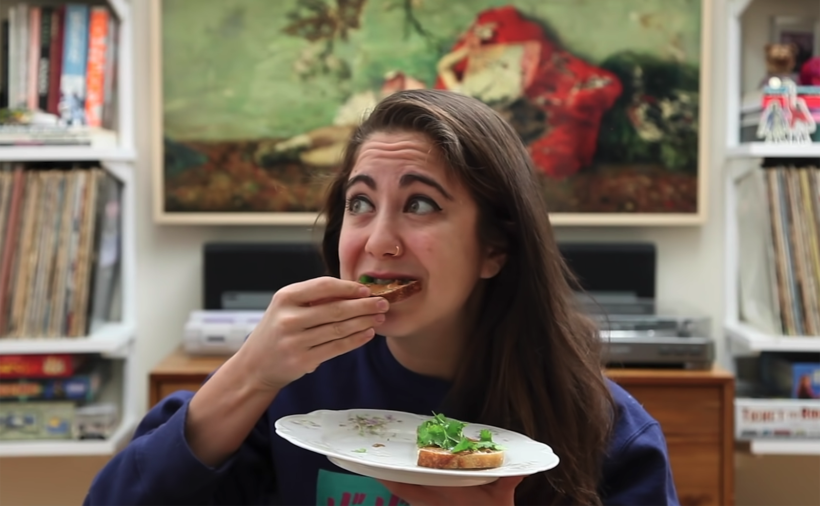 brunette girl taking a bite of toast while holding a plate