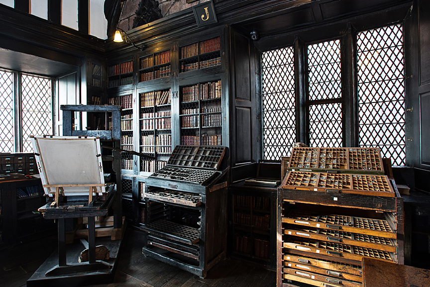 bookshelves and a vintage printing press at chethams library