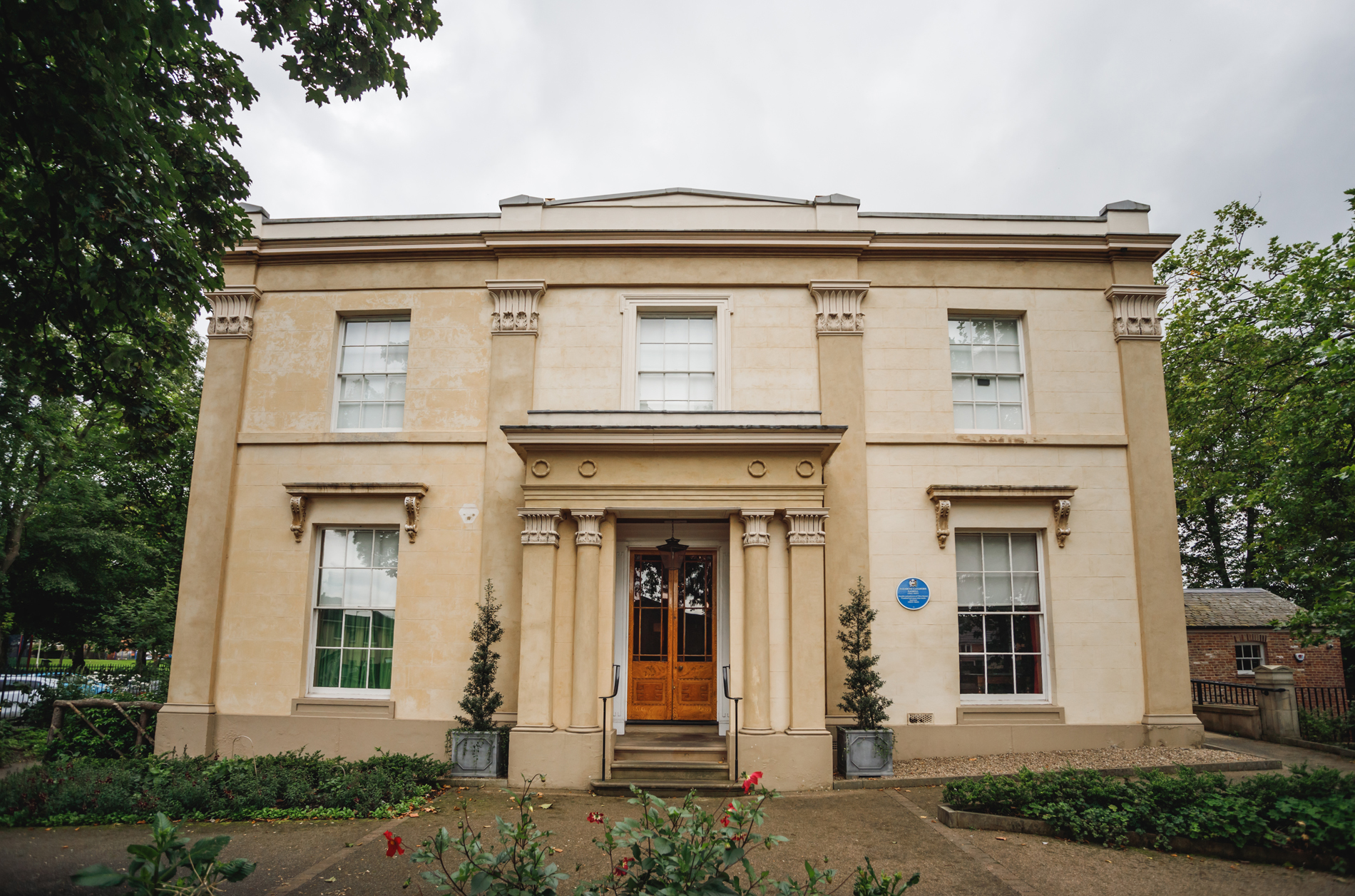 facade of a white stucco victorian villa