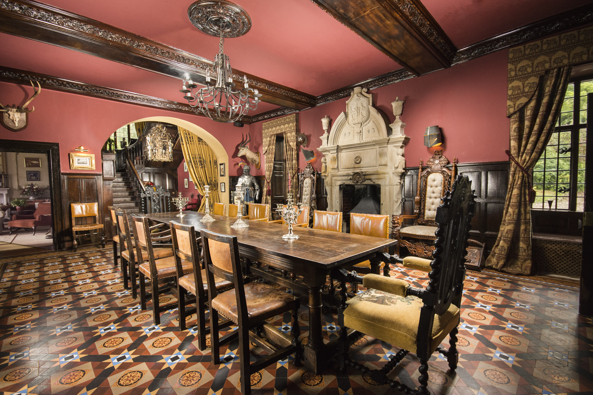 dining room decorated with suits of armor and a long wooden table surrounded by chairs