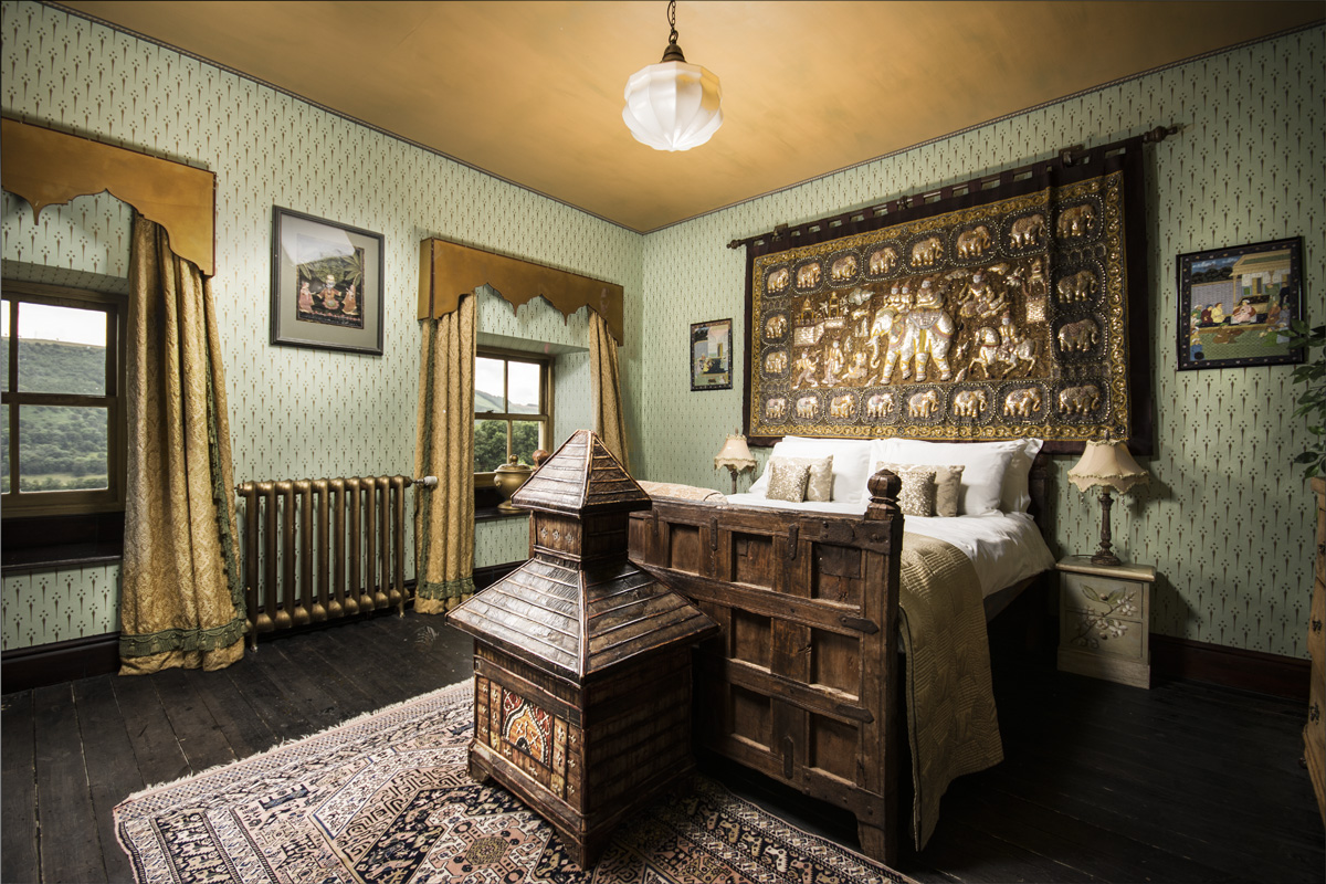 bedroom decorated with a tapestry of an elephan