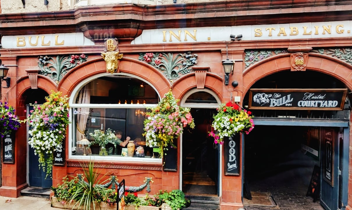 pub with baskets of flowers hanging in front