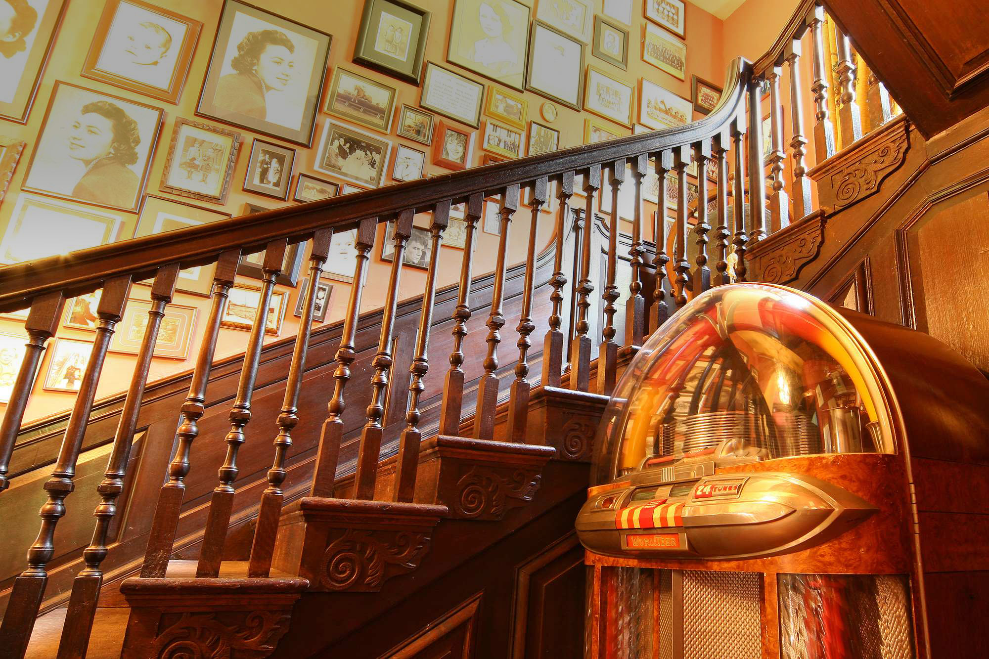 wooden stairway lined with vintage photographs