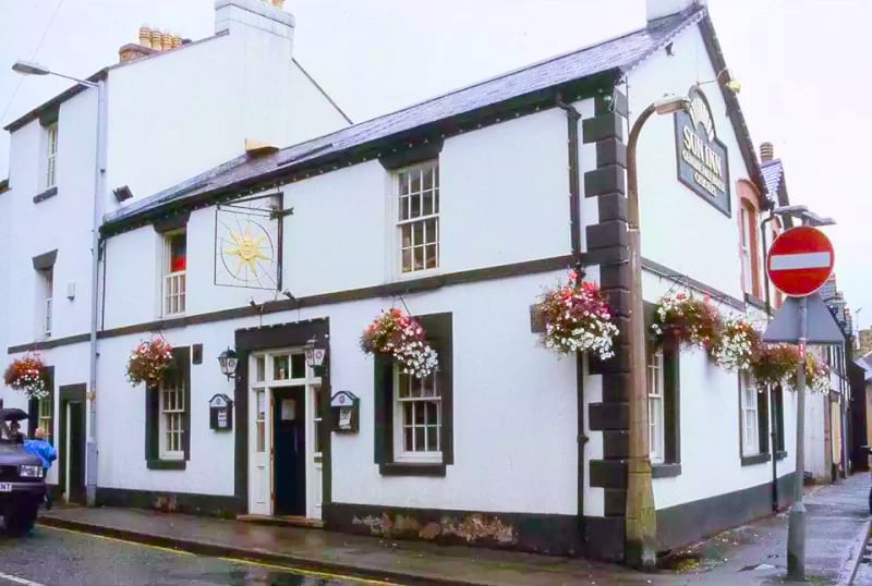 pub with baskets of flowers hanging in front