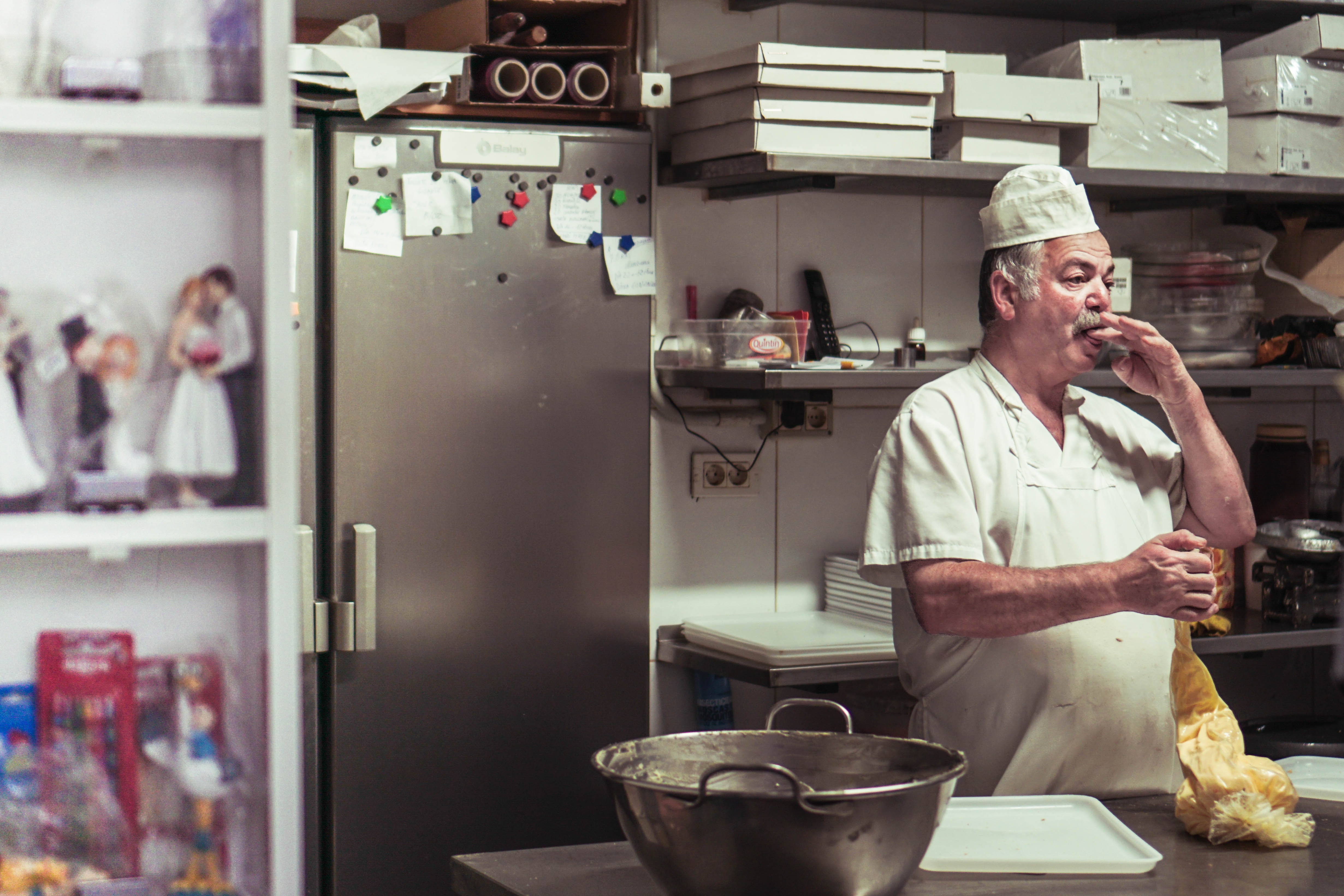 gray-haired chef with mustache in a bakery kitchen
