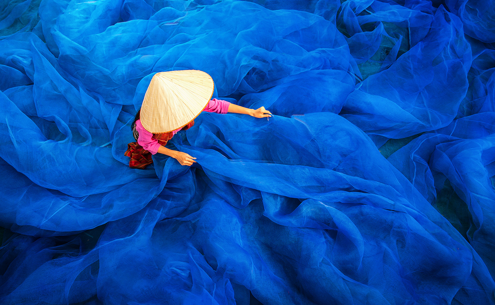 overhead view of a woman in a straw hat