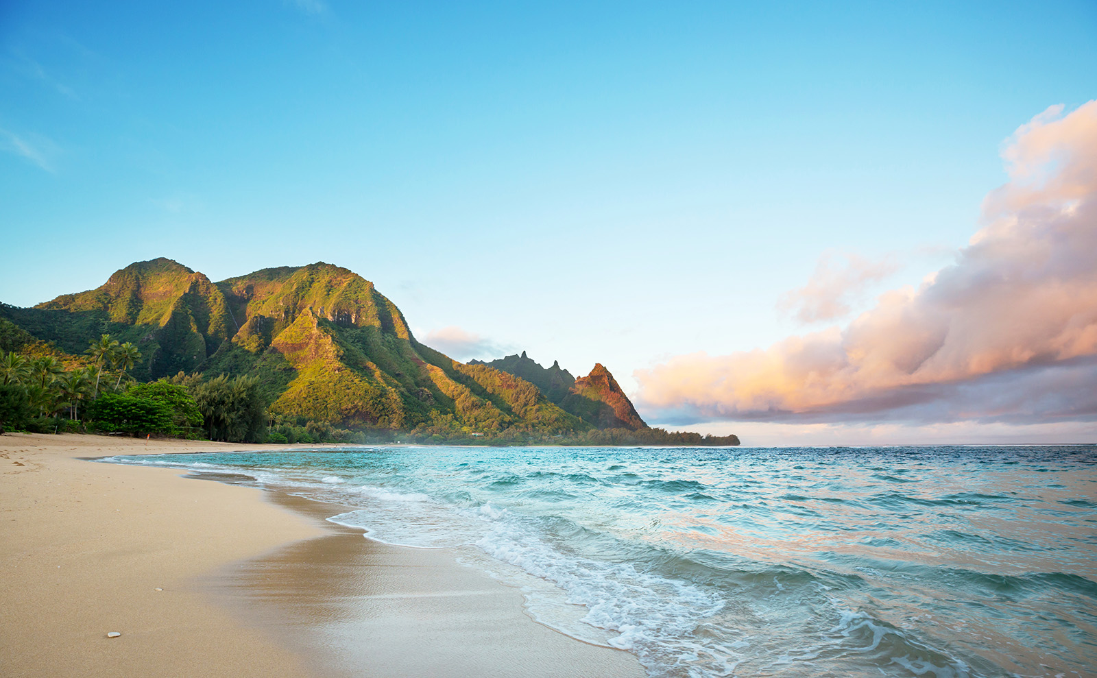 curving beach with gray cliffs and turquoise blue water