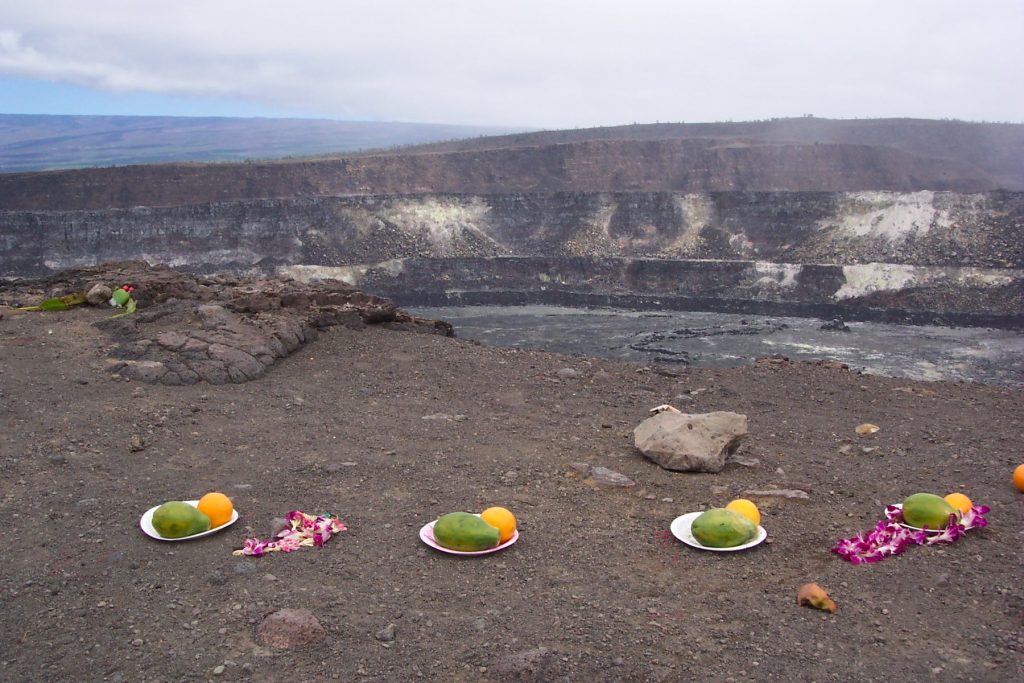 mangoes and flower leis left for pele at the edge of a volcano