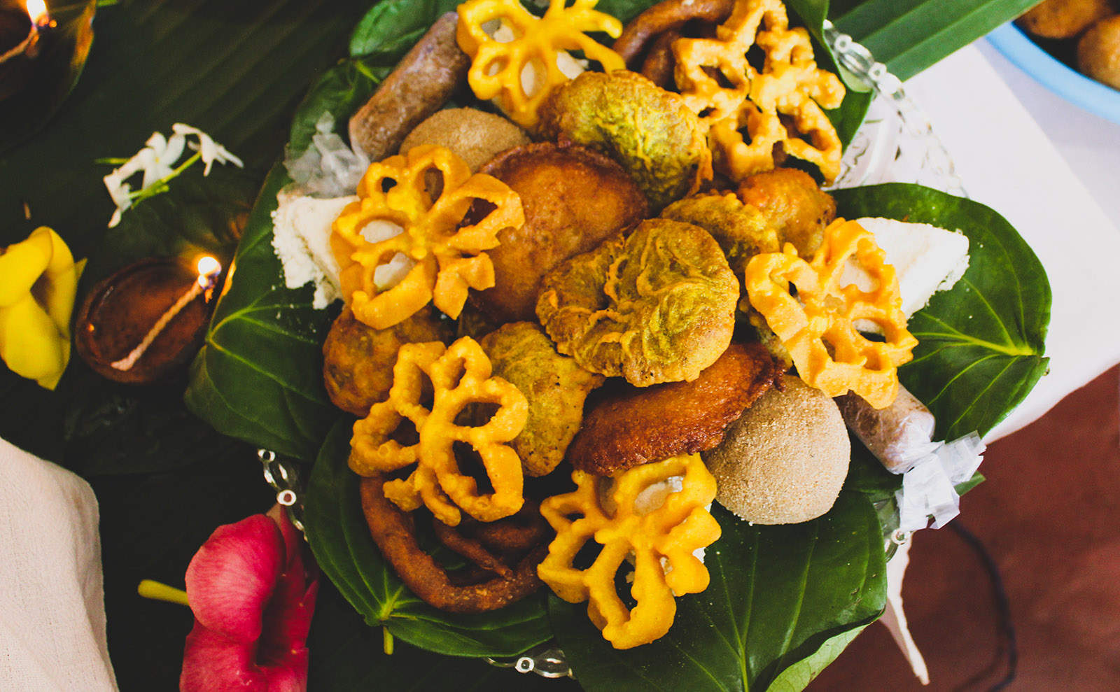an overhead view of a plate of fried food with orchids next to the plate