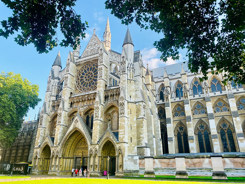 the gothic facade of westminster abbey in london on a sunny day