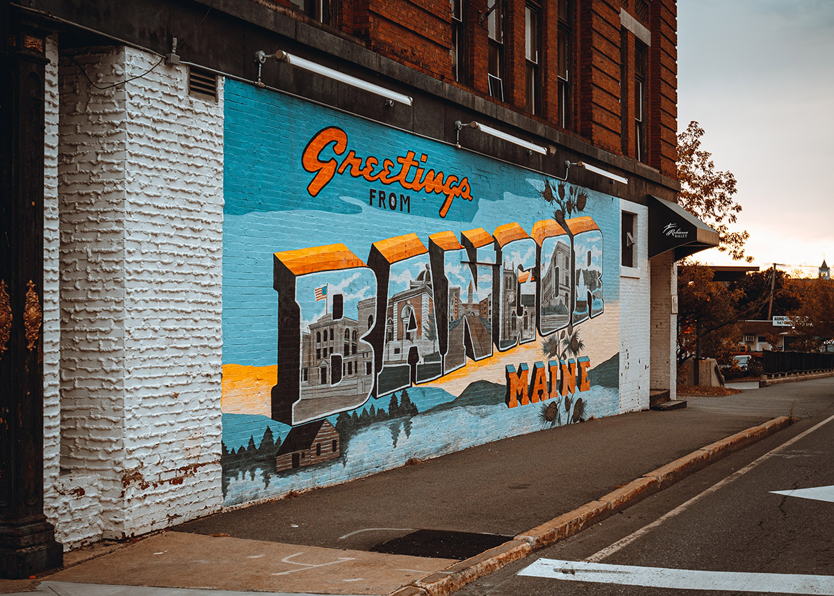colorful mural depicting the town of bangor maine on a brick wall