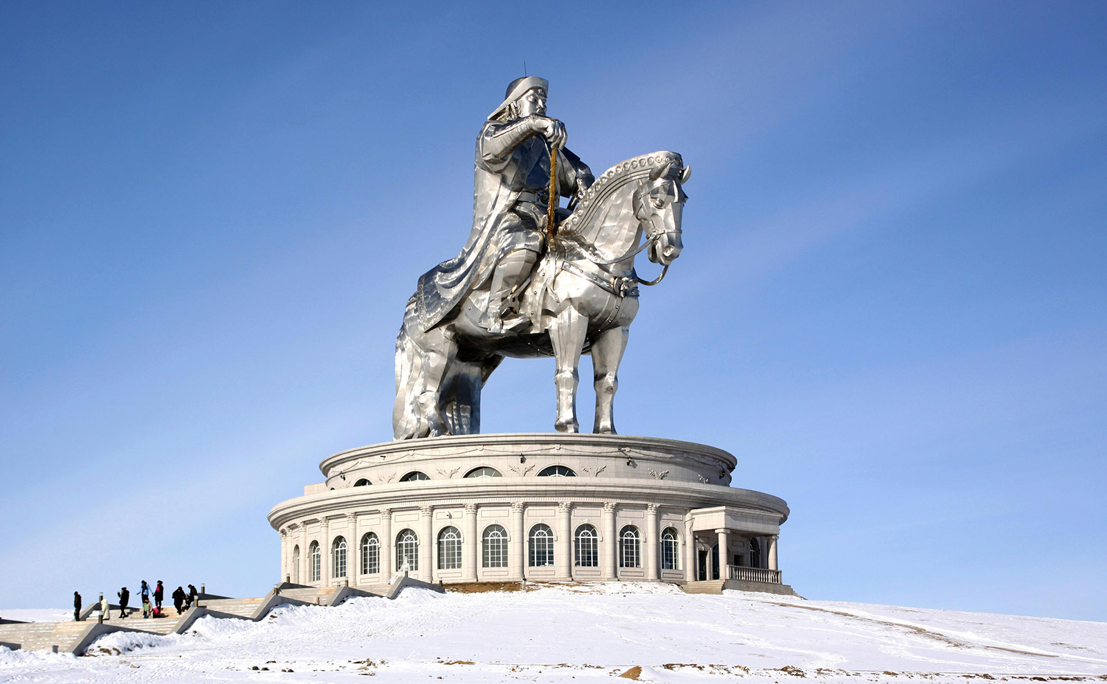 enormous shiny silver statue of chingiss khan sitting on a horse