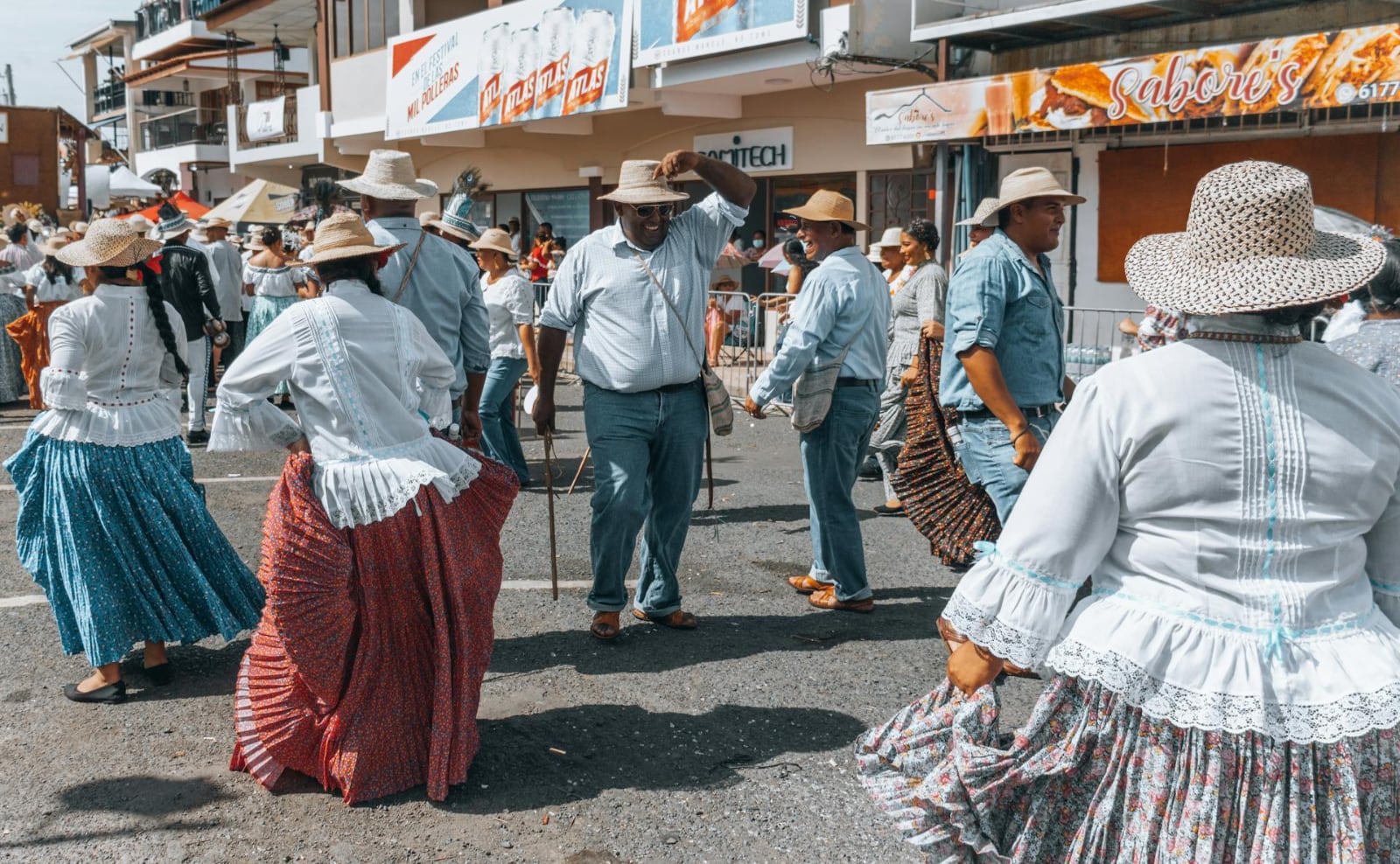 people in panamanian folk costumes dancing in the street in panama city