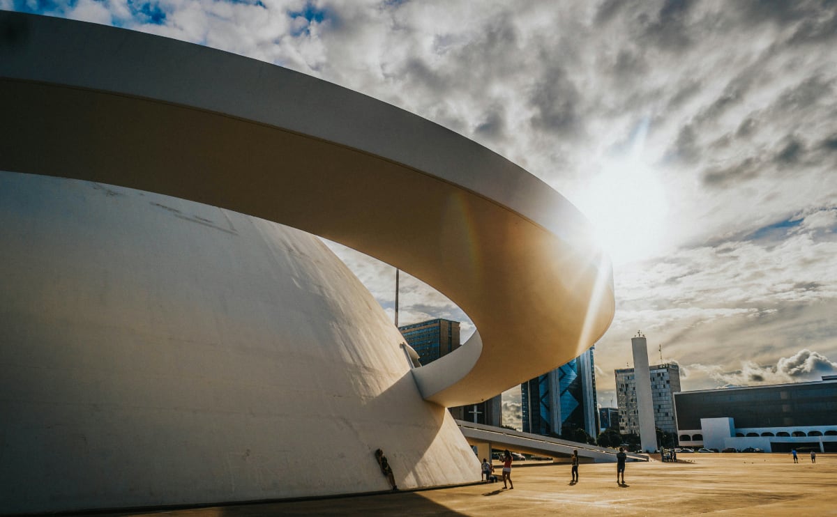 white concrete building with the sun shining on it