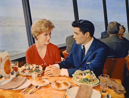 elvis presley sitting by the window of the revolving restaurant at the top of the space needle