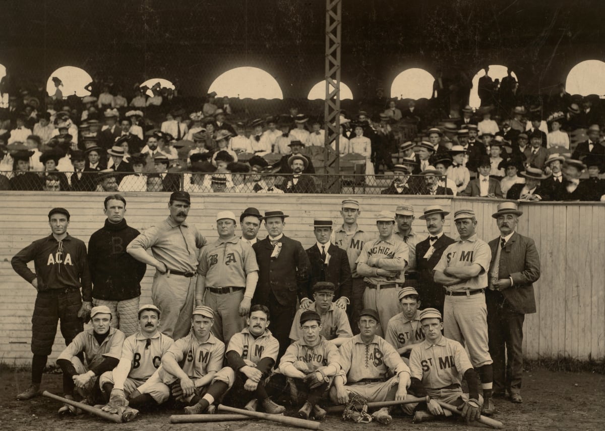 black and white photo of old-timey baseball team posed on the field