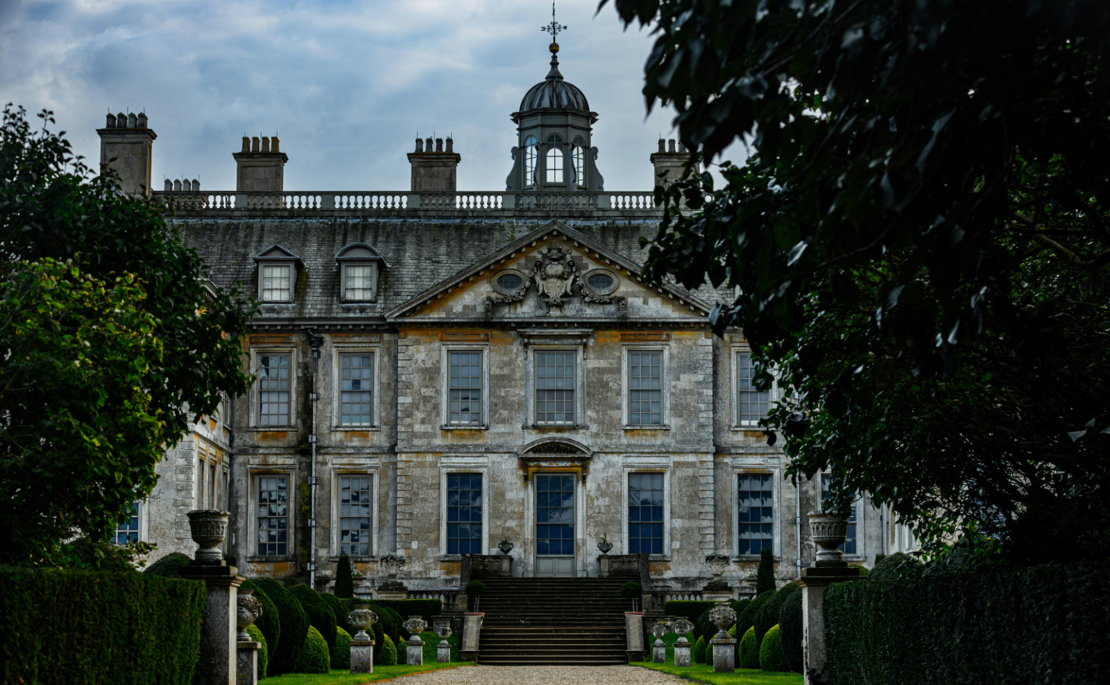 gray stone building surrounded with green bushes