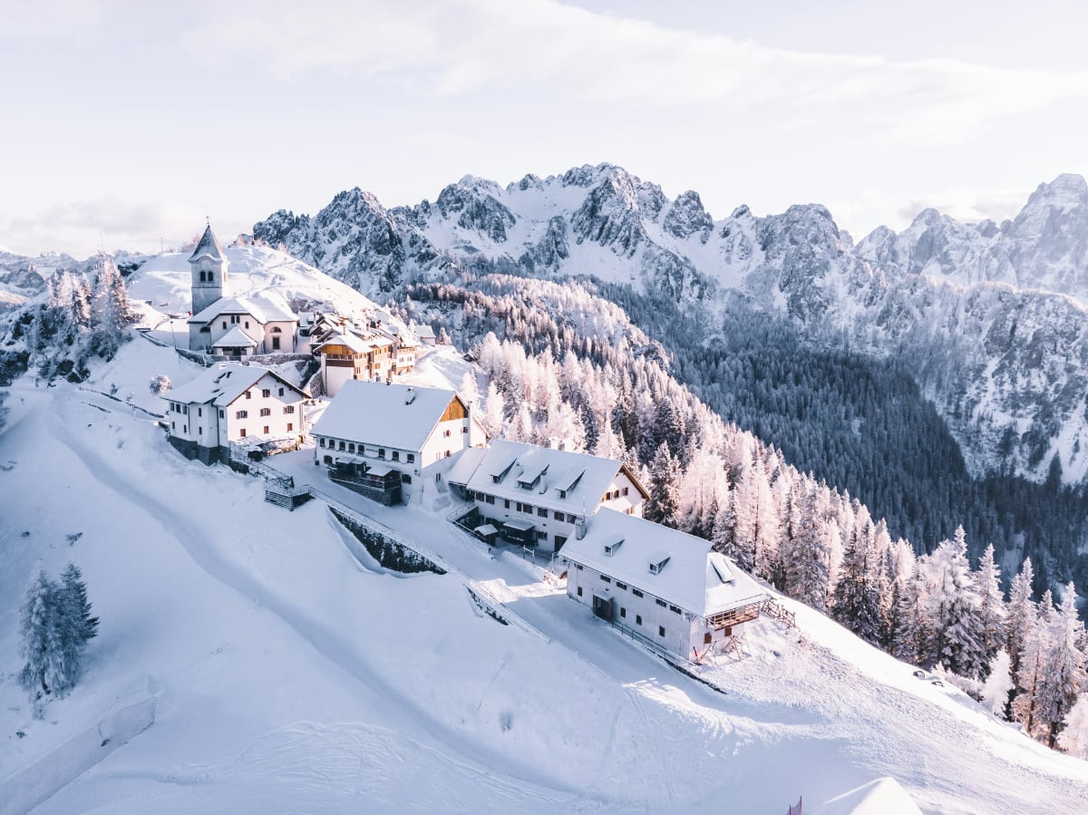 snowy mountain top with buildings