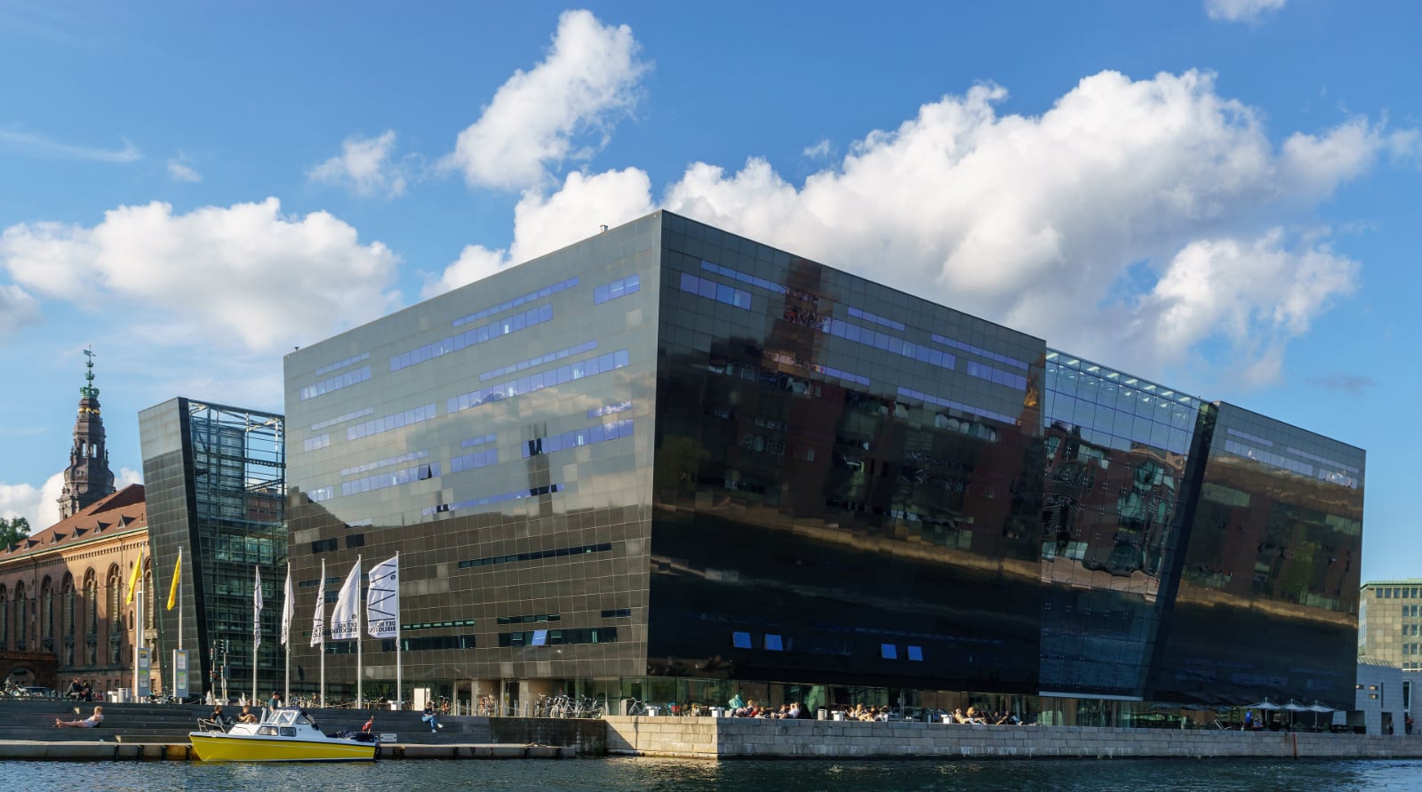 black reflective angular building under a clear blue sunny sky