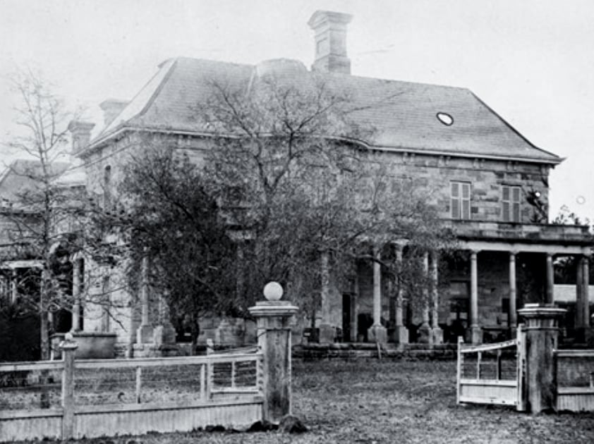 black and white photo of a stone manor house