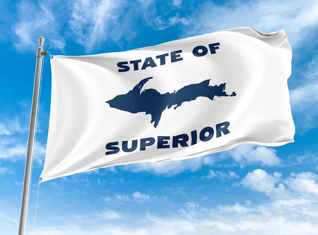 white flat with blue silhouette of michigan upper peninsula against a bright blue sky