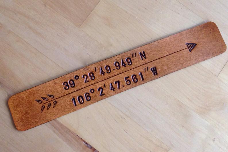 brown leather bookmark stamped with longitude and latitude