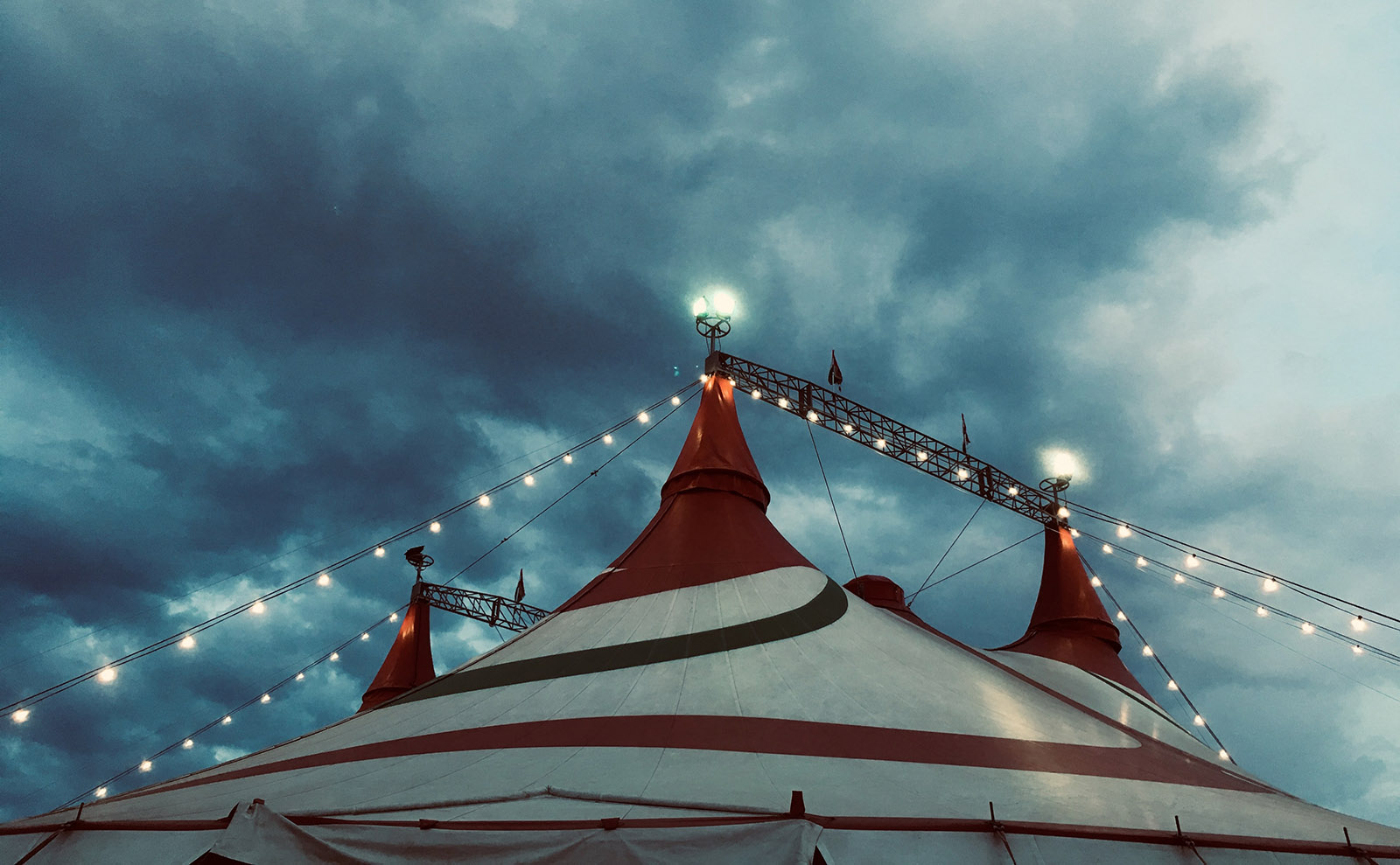 stormy night sky with a striped circus tent.