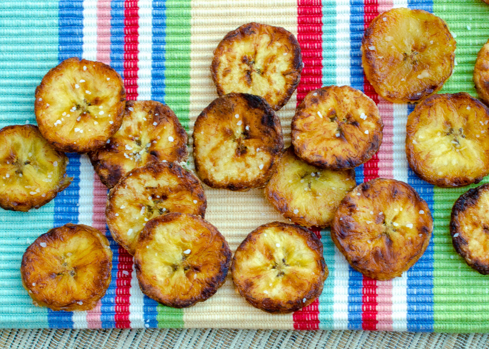  fried plantain slices on a colored background