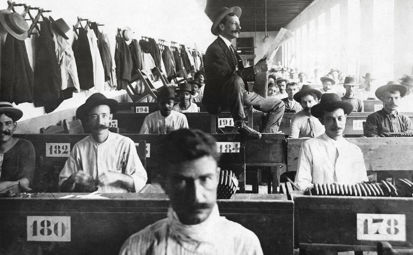 a gentleman reads to tobacco factory workers in cuba