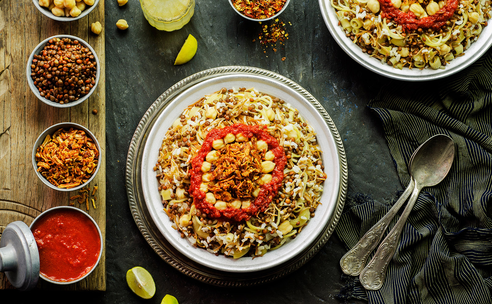 a bowl of kushari on a wooden table