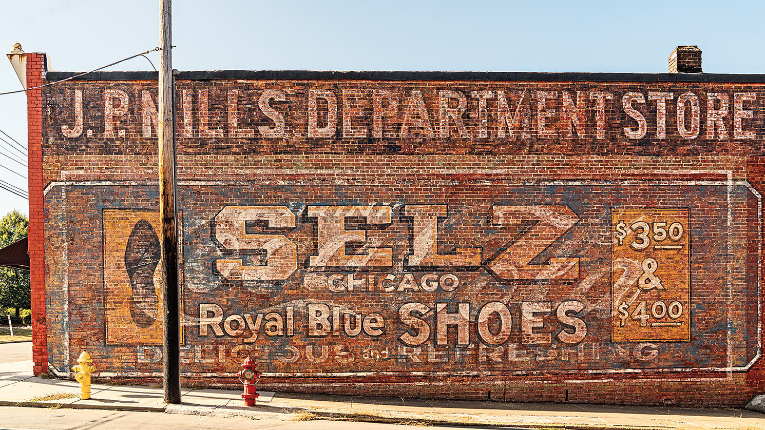 vintage sign painted on a red brick wall