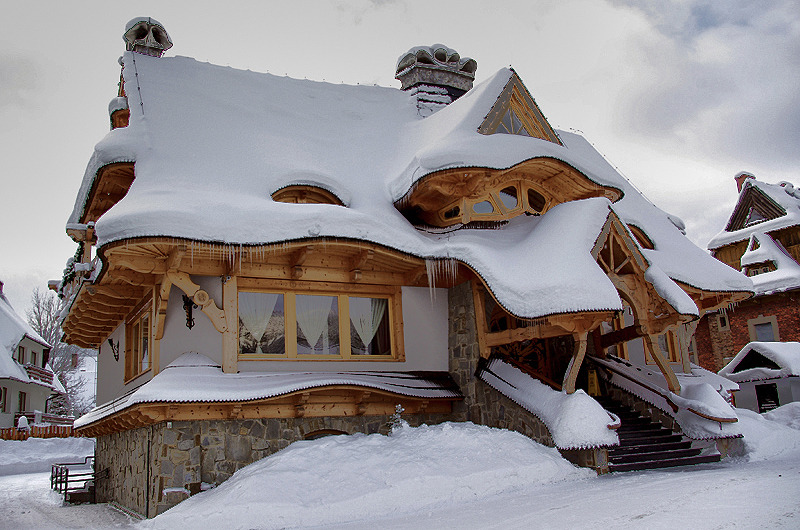 snow-covered wooden cabin in poland