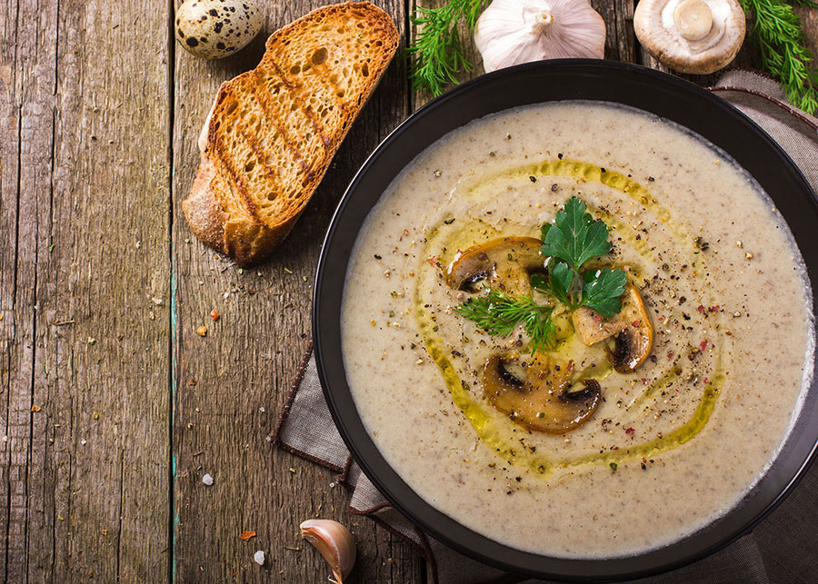 mushroom soup in a bowl on a wooden table