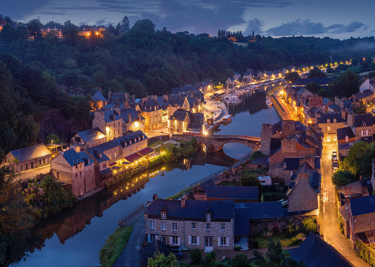 overhead view of a quaint town along a river at night