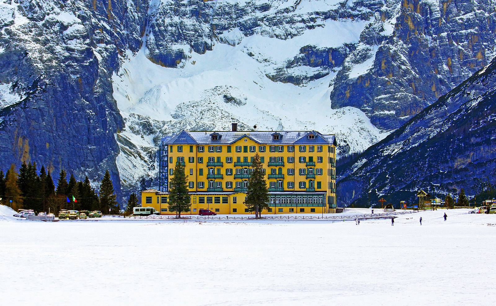 large yellow hotel on a snowy mountain