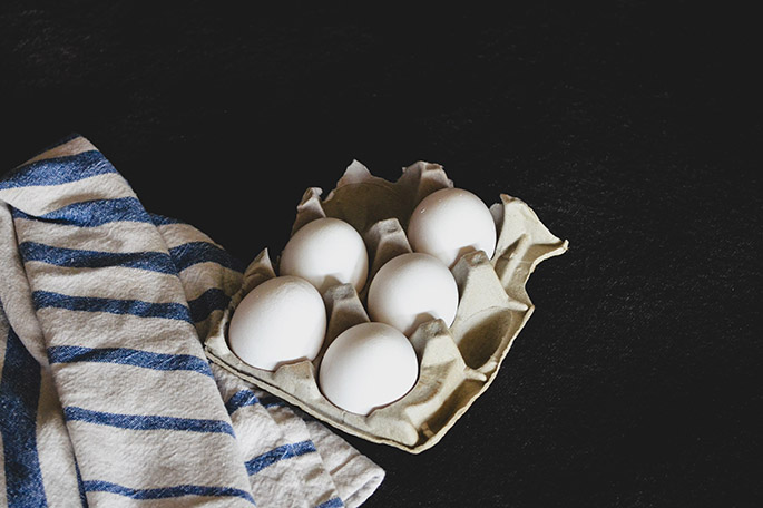 eggs in a carton on a black background