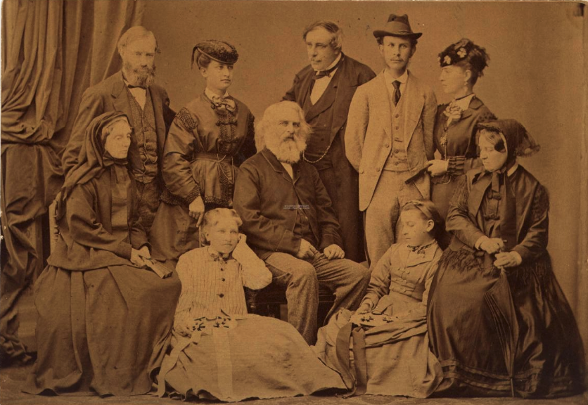  sepia-toned photo of henry wadsworth longfellow with his family in 1869