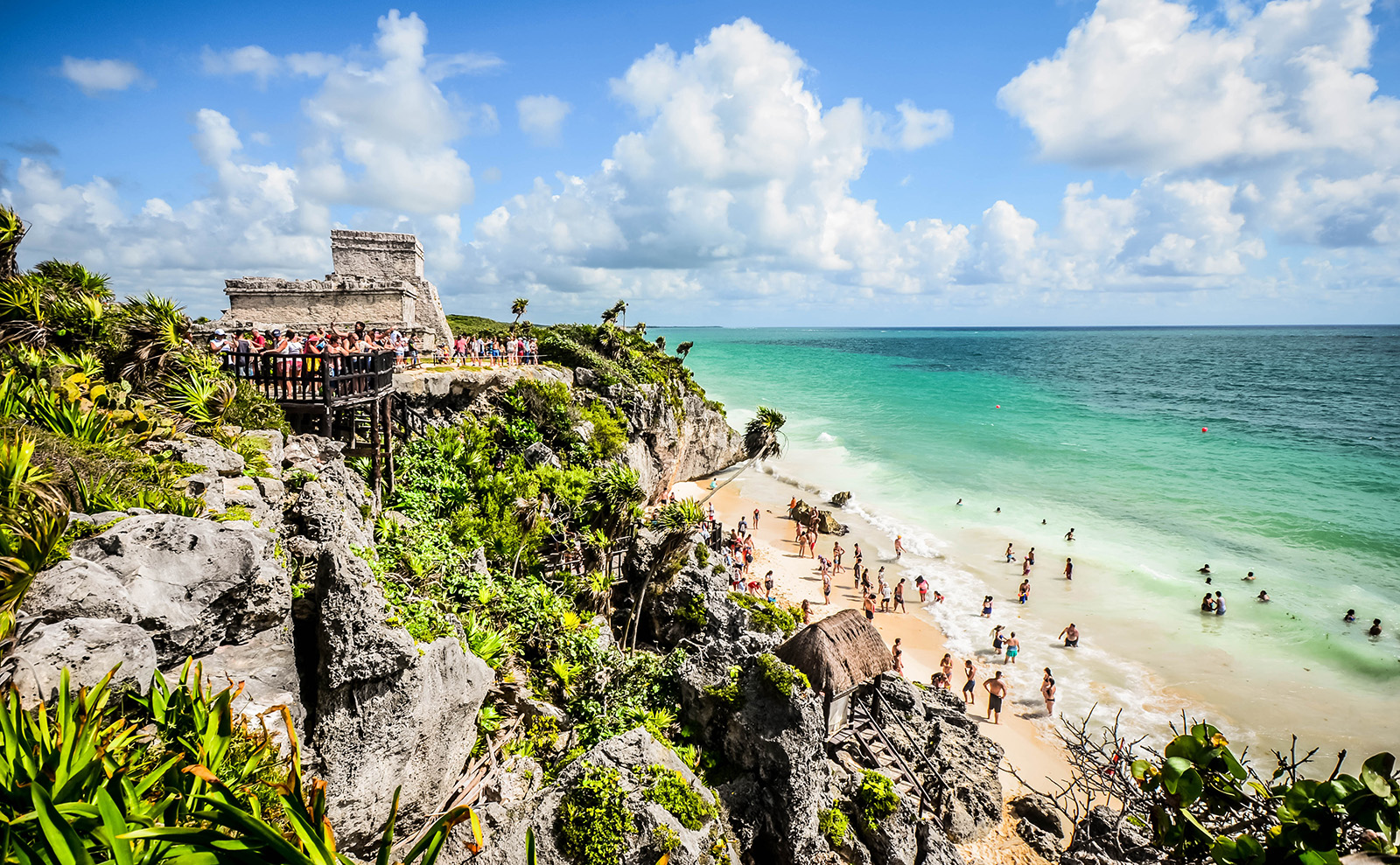 mayan ruins on a cliff above a beach in tulum, mexico