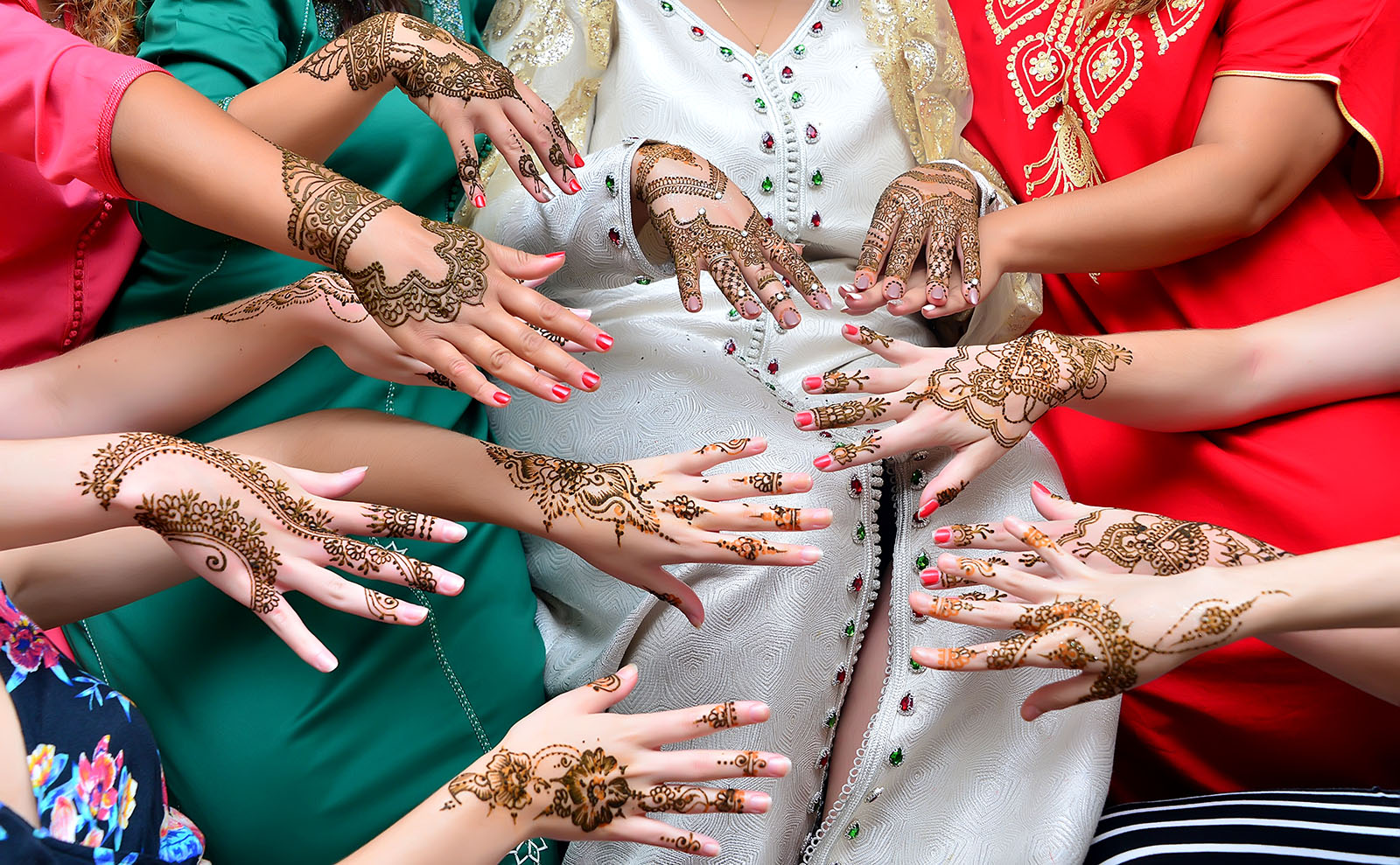 several women displaying henna tattoos