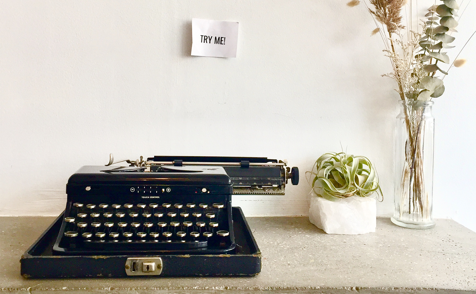 vintage typewriter on a table with flowers