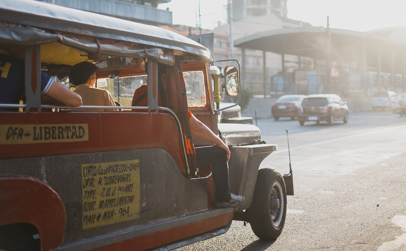 vintage car driving down manila street