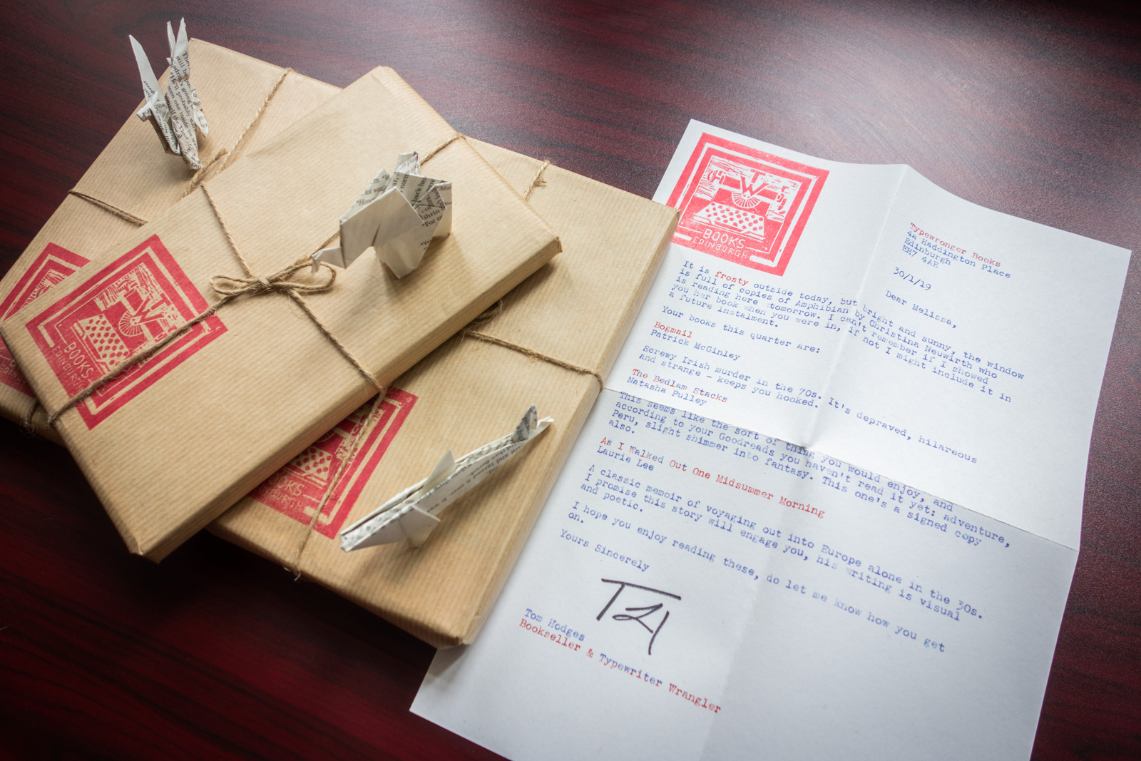 three books wrapped in brown paper