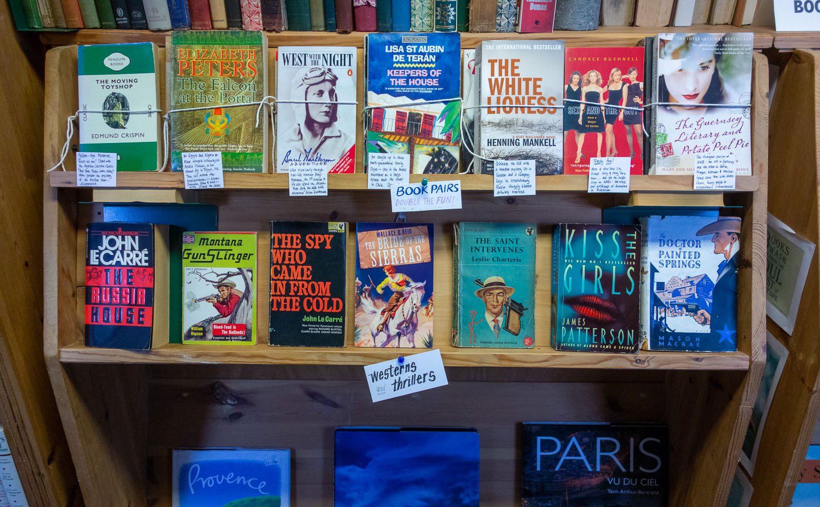 paperback books on a wooden shelf