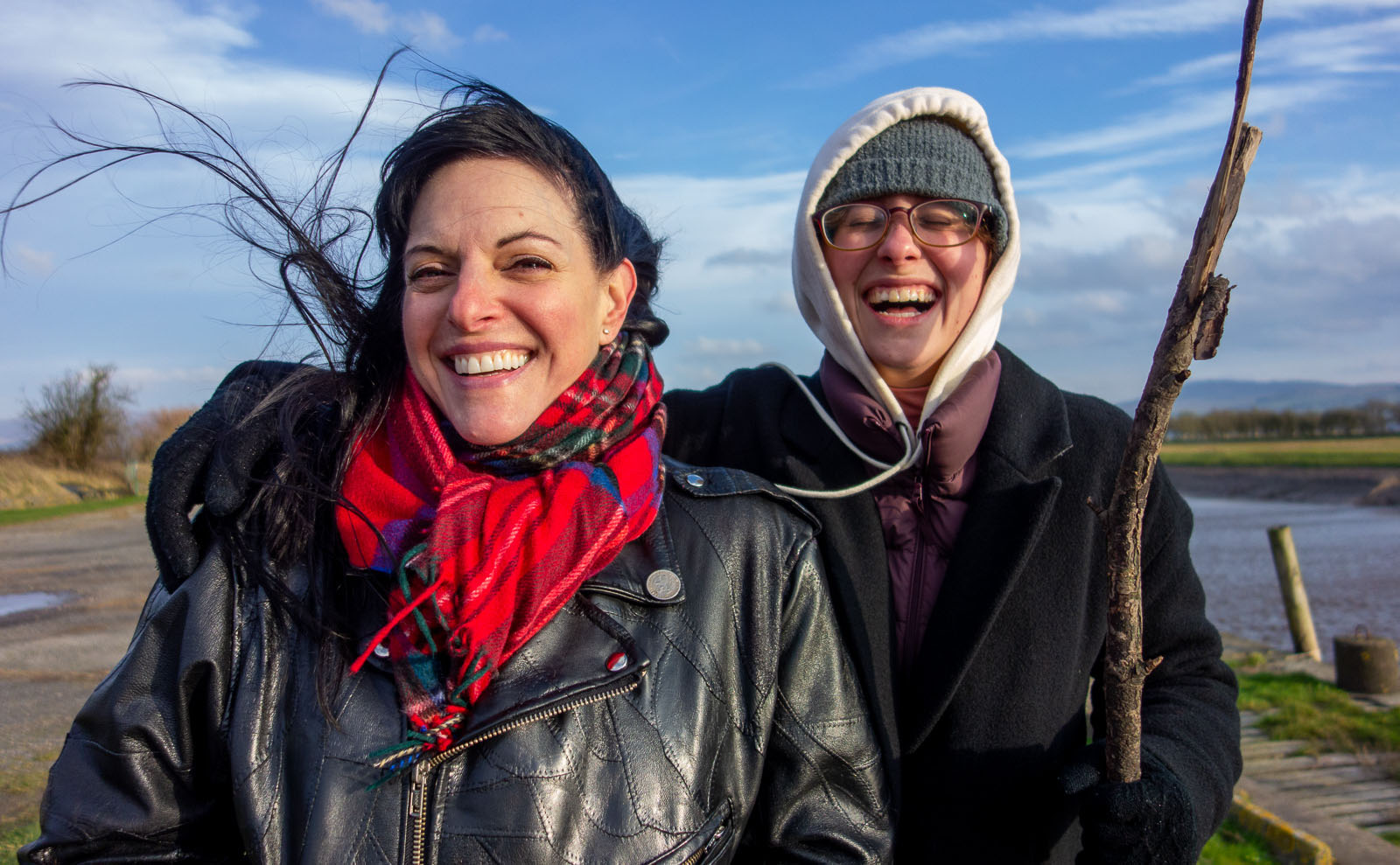 two people with their hair blowing in the wind