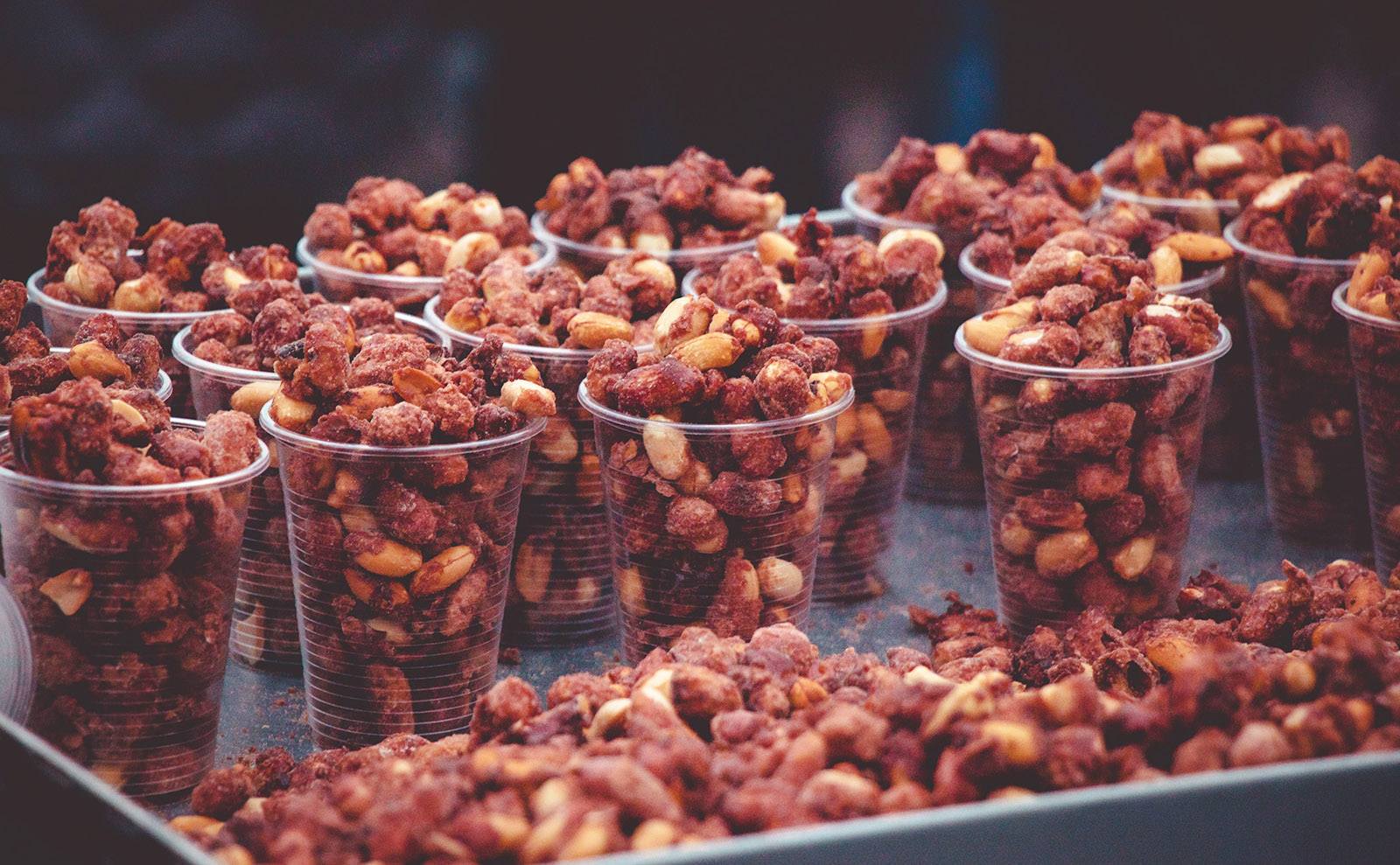 rows of brown sugared nuts in cups