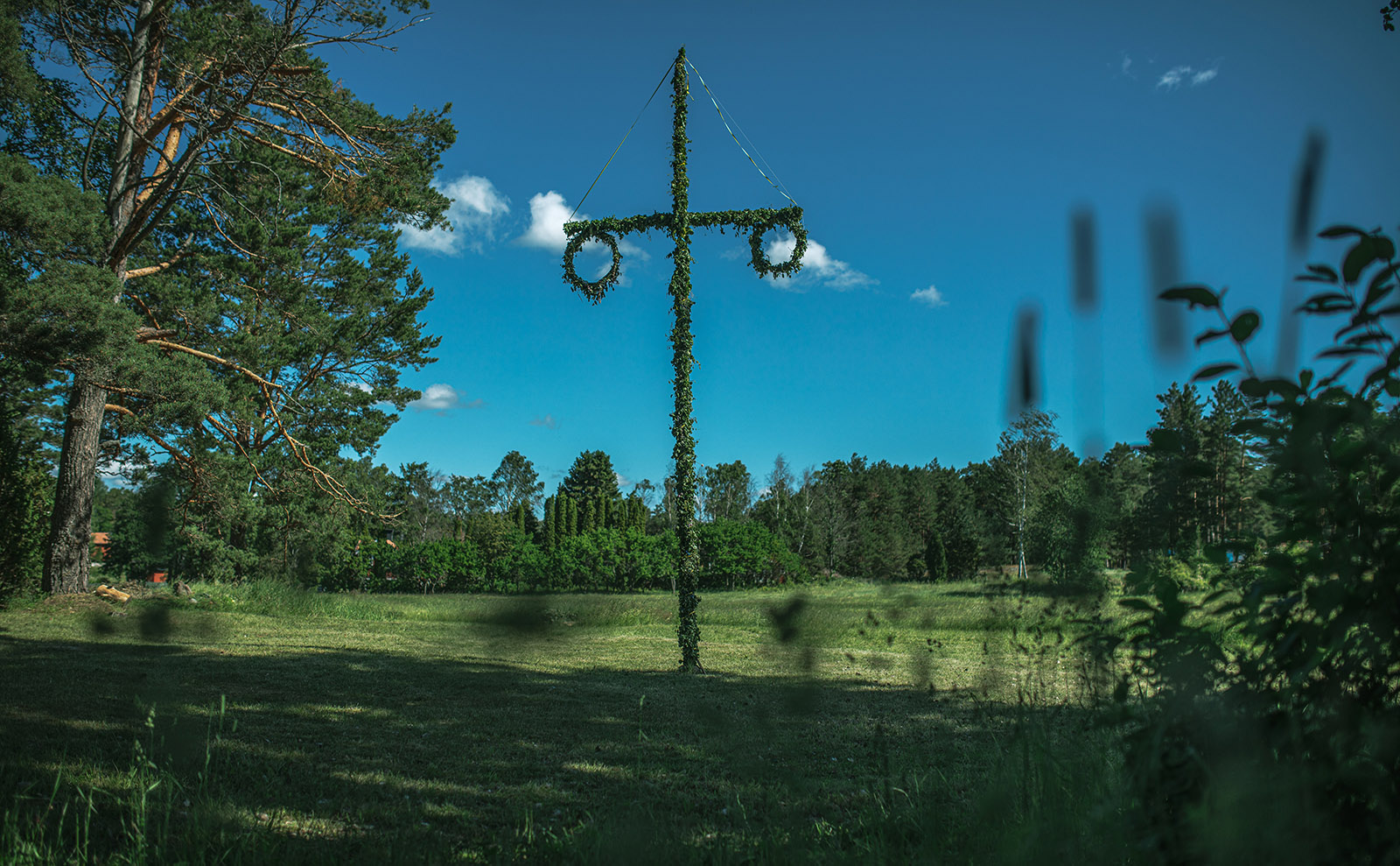 midsommar pole in a green field in sweden